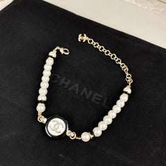 Classic CC bracelet with faux pearls and black resin.