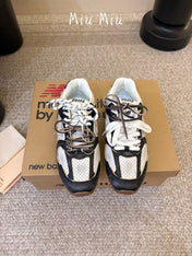 MIUMIU 26S PERFORATED SNEAKERS IN WHITE AND BLACK CALFSKIN