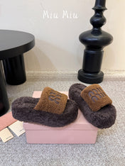 MIUMIU 26S PLATFORM SLIDES IN DARK BROWN SHEARLING