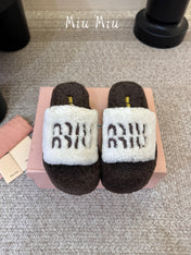 MIUMIU 26S PLATFORM SLIDES IN DARK BROWN AND WHITE SHEARLING