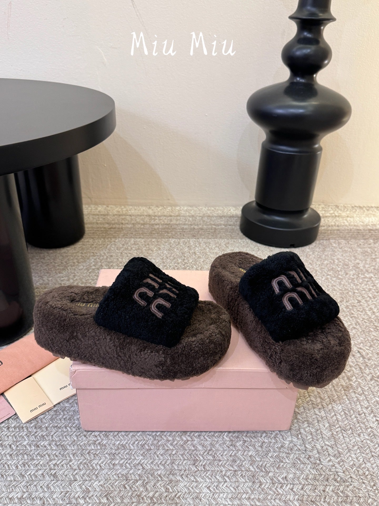 MIUMIU 26S PLATFORM SLIDES IN DARK BROWN AND BLACK SHEARLING