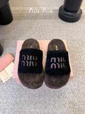 MIUMIU 26S PLATFORM SLIDES IN DARK BROWN AND BLACK SHEARLING