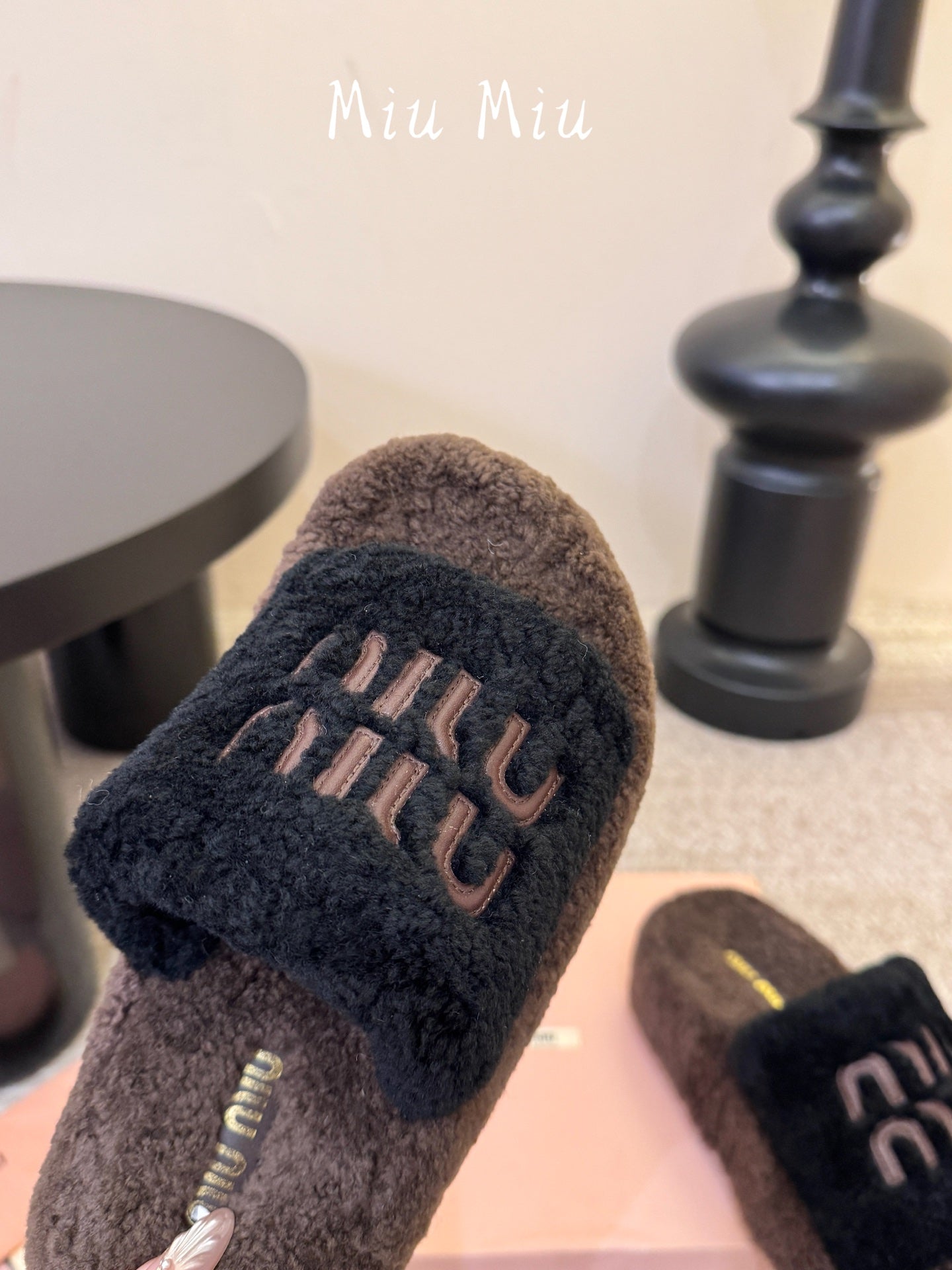 MIUMIU 26S PLATFORM SLIDES IN DARK BROWN AND BLACK SHEARLING