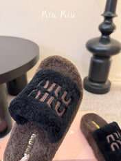 MIUMIU 26S PLATFORM SLIDES IN DARK BROWN AND BLACK SHEARLING