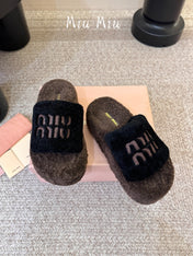 MIUMIU 26S PLATFORM SLIDES IN DARK BROWN AND BLACK SHEARLING