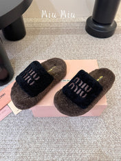MIUMIU 26S PLATFORM SLIDES IN DARK BROWN AND BLACK SHEARLING