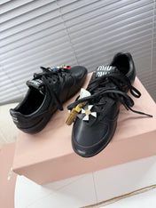 MIUMIU 26S GYMNASIUM SNEAKER IN BLACK CALFSKIN WITH GOLD BUCKLED STRAP