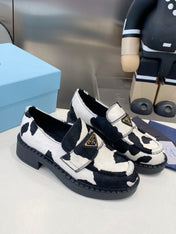 PRADA 26S LOAFERS IN WHITE AND BLACK COW PRINT PONY HAIR