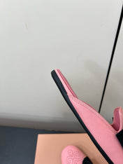 BOW MULES IN PINK SHEEPSKIN