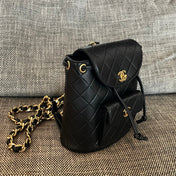 CHANEL 26S BACKPACK WITH FRONT POCKET 21 IN BLACK QUILTED LAMBSKIN GOLD HARDWARE