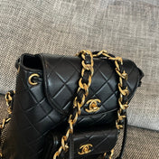 CHANEL 26S BACKPACK WITH FRONT POCKET 21 IN BLACK QUILTED LAMBSKIN GOLD HARDWARE