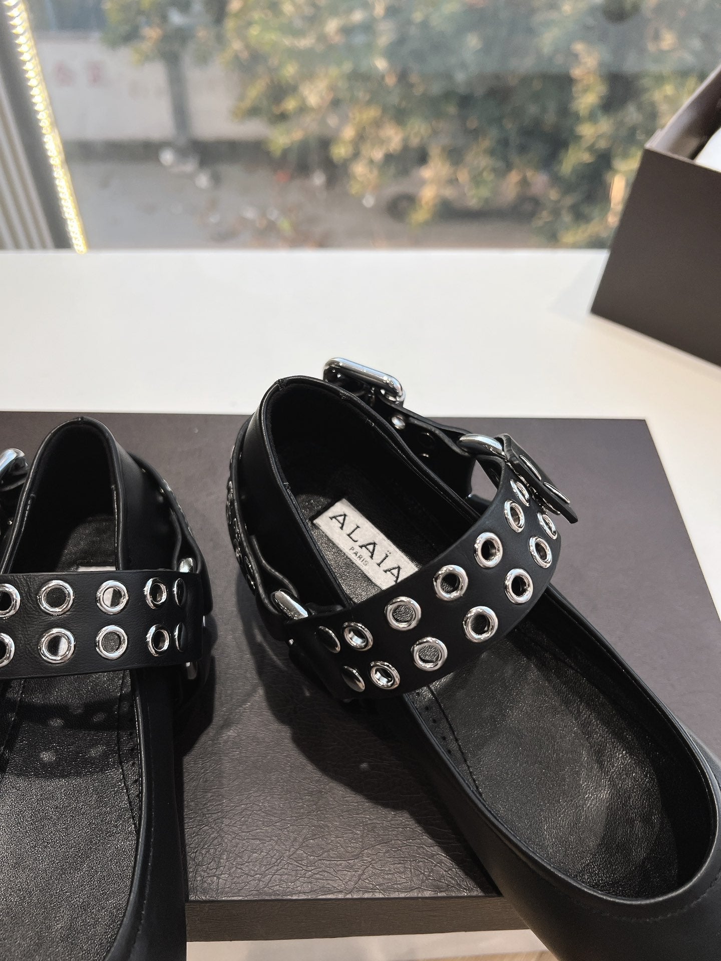 ALAIA 26S FLATS IN BLACK CALFSKIN WITH SILVER STUD STRAP