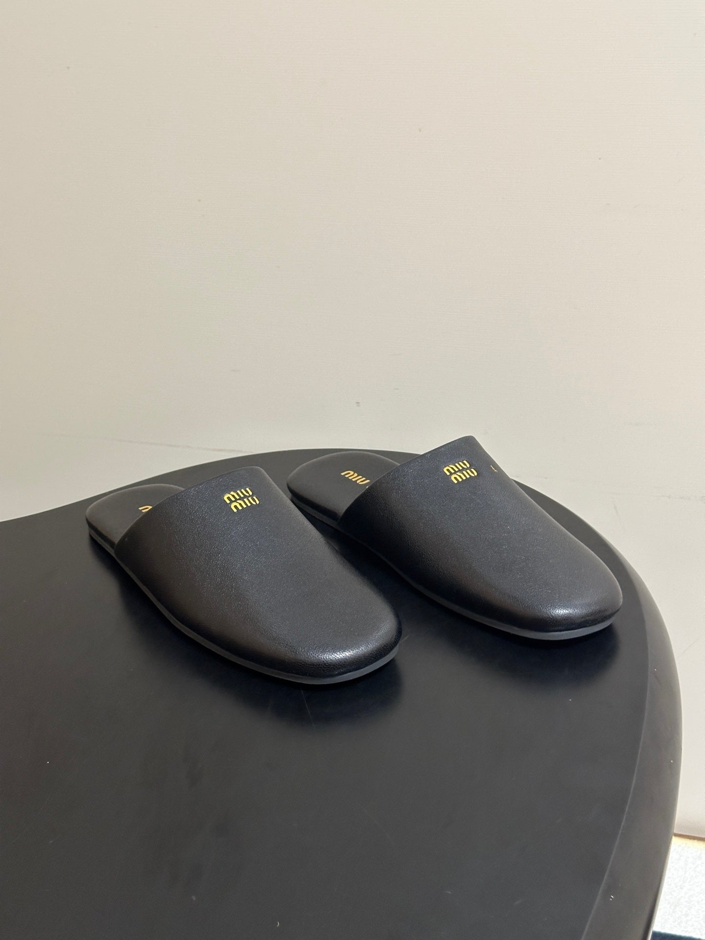 MIUMIU 26S MULE LOAFERS IN BLACK CALSKIN
