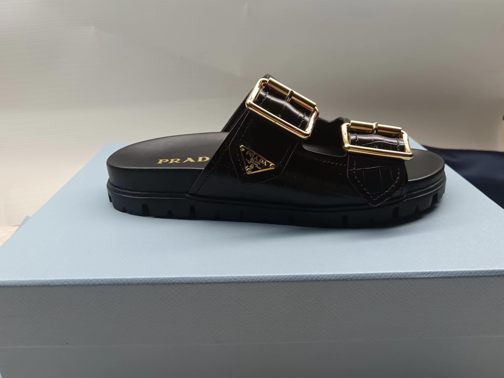PRADA 26S STRAP SLIDES IN BLACK CROC EMBOSSED CALFSKIN GOLD HARDWARE