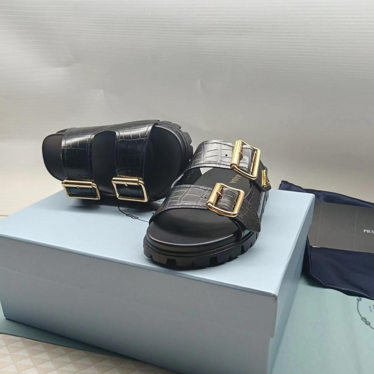PRADA 26S STRAP SLIDES IN BLACK CROC EMBOSSED CALFSKIN GOLD HARDWARE