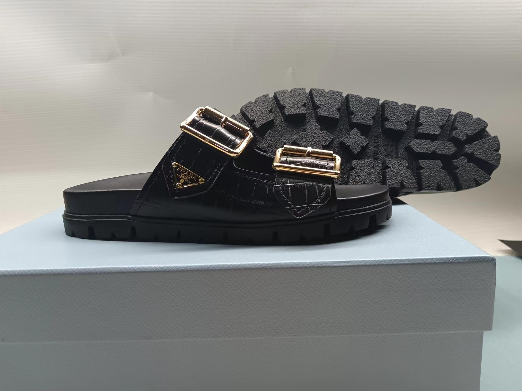 PRADA 26S STRAP SLIDES IN BLACK CROC EMBOSSED CALFSKIN GOLD HARDWARE