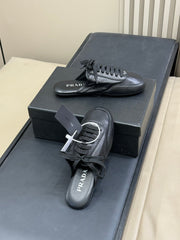 PRADA 25S COLLAPSE MULES IN BLACK CALFSKIN