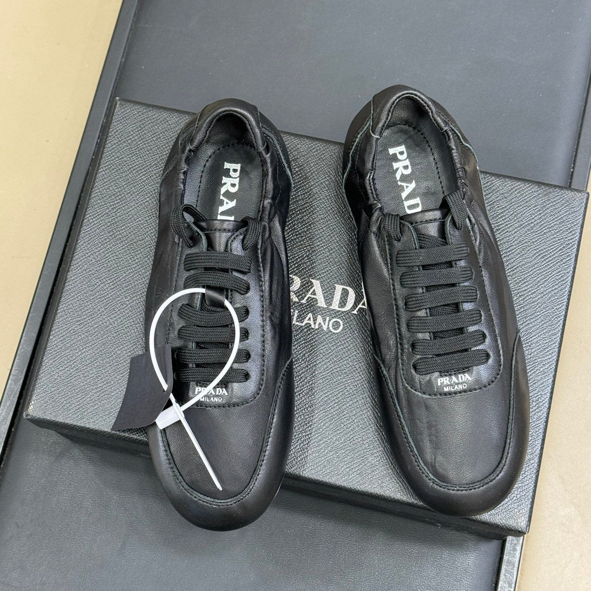 PRADA 25S COLLAPSE FLAT SHOES IN BLACK CALFSKIN