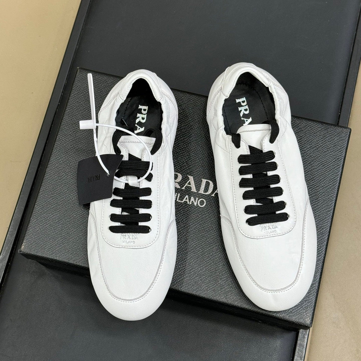 PRADA 25S COLLAPSE FLAT SHOES IN WHITE CALFSKIN
