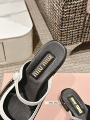 FLAT MULE IN BLACK AND WHITE PATENT CALFSKIN