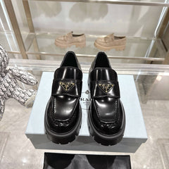 PRADA 25S THICK-SOLE LOAFERS 60 MM IN BLACK CALFSKIN