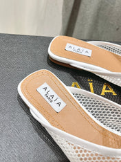 ALAIA FLAT MULES IN WHITE MESH FISHNET