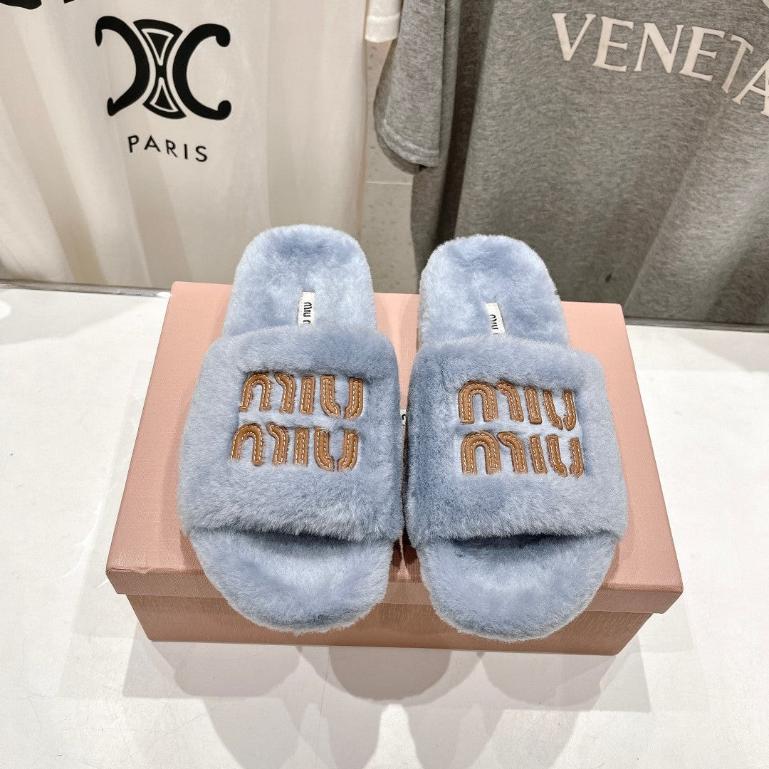 MIUMIU 26S FLAT SLIDES IN PASTEL BLUE SHEARLING