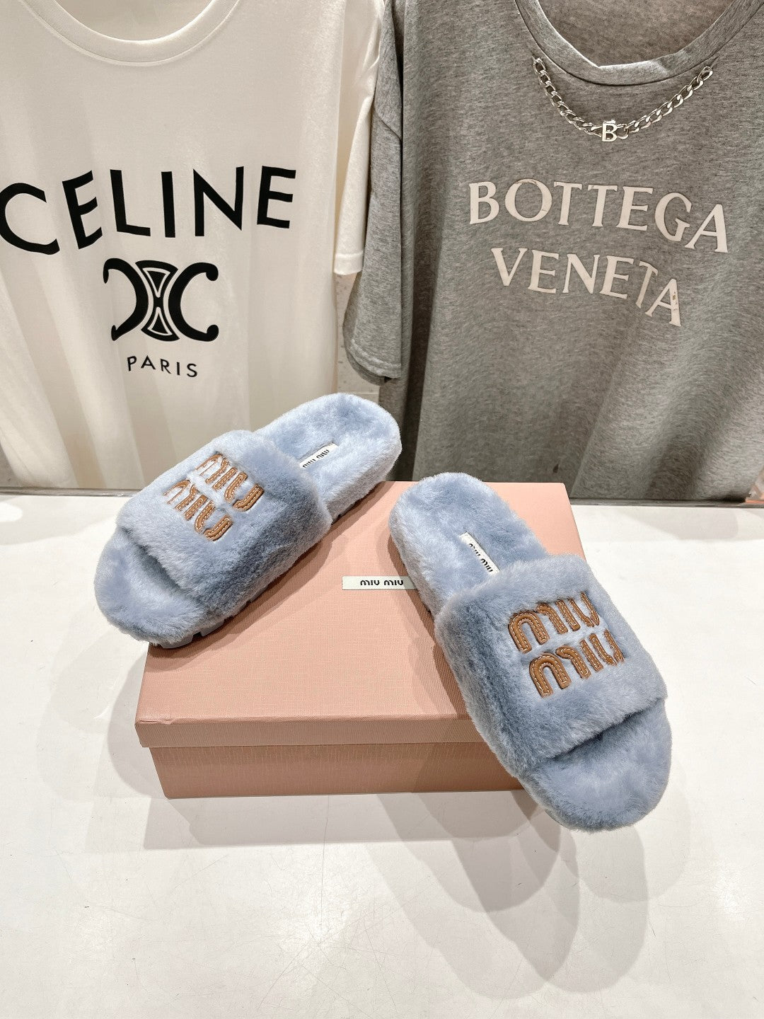 MIUMIU 26S FLAT SLIDES IN PASTEL BLUE SHEARLING
