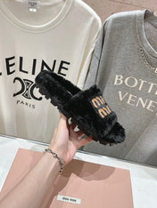 MIUMIU 26S FLAT SLIDES IN BLACK SHEARLING