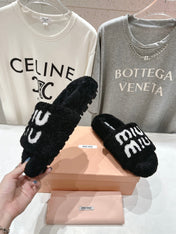 MIUMIU 26S SANDALS IN BLACK SHEARLING WITH LOGO LETTERING
