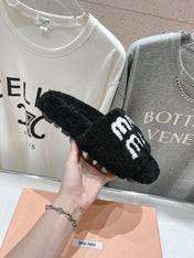 MIUMIU 26S SANDALS IN BLACK SHEARLING WITH LOGO LETTERING
