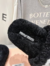MIUMIU 26S SANDALS IN BLACK SHEARLING WITH LOGO LETTERING