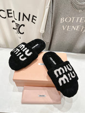 MIUMIU 26S SANDALS IN BLACK SHEARLING WITH LOGO LETTERING
