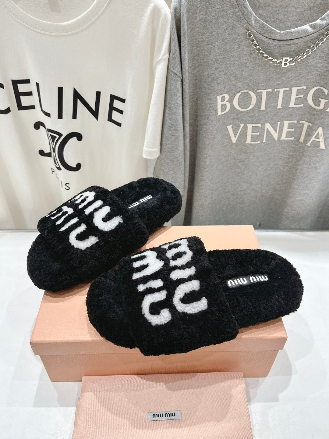 MIUMIU 26S SANDALS IN BLACK SHEARLING WITH LOGO LETTERING