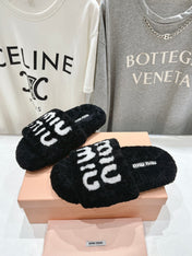 MIUMIU 26S SANDALS IN BLACK SHEARLING WITH LOGO LETTERING