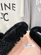 MIUMIU 26S SANDALS IN BLACK SHEARLING WITH LOGO LETTERING