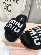 MIUMIU 26S SANDALS IN BLACK SHEARLING WITH LOGO LETTERING