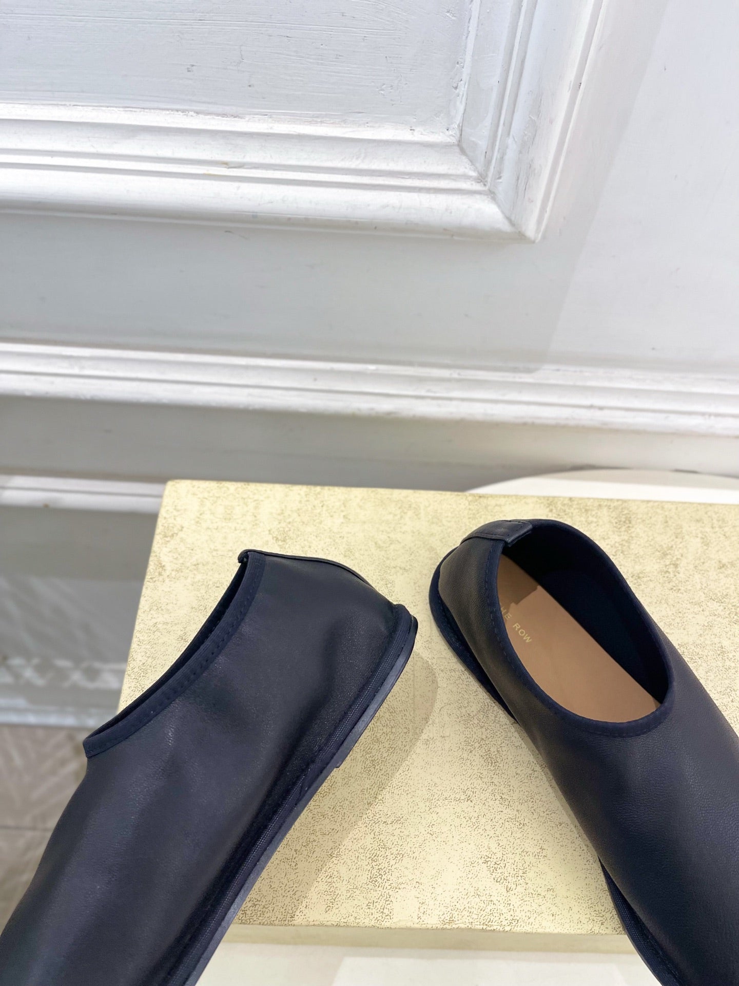 THE ROW 26S SLIP-ON FLATS IN BLACK NAPPA CALFSKIN