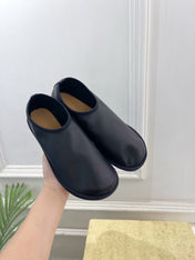 THE ROW 26S SLIP-ON FLATS IN BLACK NAPPA CALFSKIN