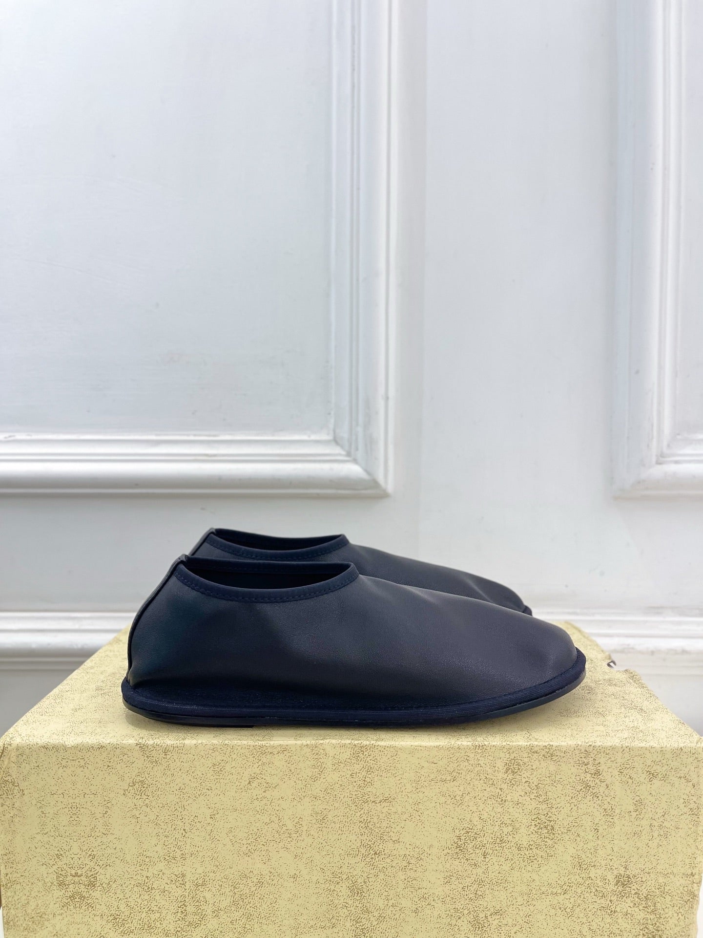 THE ROW 26S SLIP-ON FLATS IN BLACK NAPPA CALFSKIN