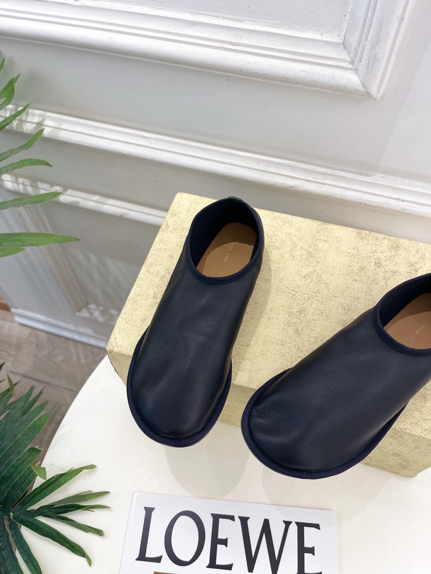 THE ROW 26S SLIP-ON FLATS IN BLACK NAPPA CALFSKIN
