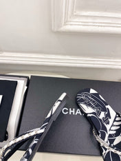 CHANEL 26S THONG SANDALS IN BLACK AND WHITE FLORAL PRINT FABRIC