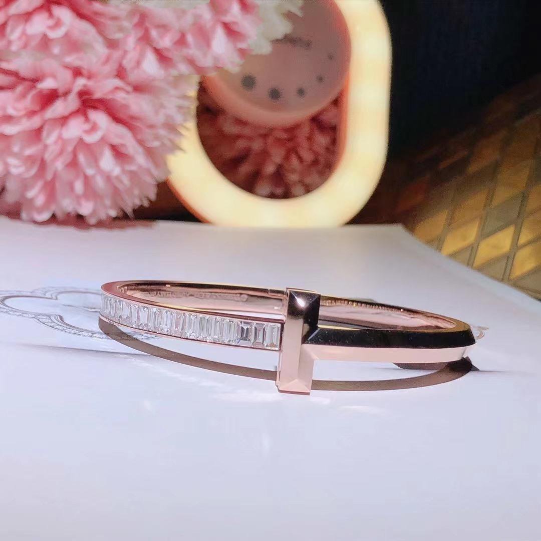 tiffany-t-t1-wide-hinged-bangle-in-18k-rose-gold-with-baguette-diamonds-coral-1_1b8f9b8e-04e6-4ca2-8759-4a5aba95b71c.jpg