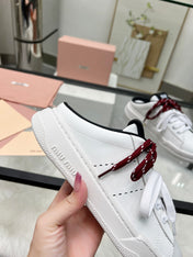 SNEAKER MULES IN BLACK AND WHITE CALFSKIN WHITE RED LACES